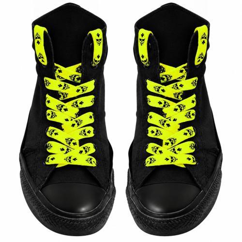 Neon yellow skull print shoelaces on black high-top sneakers