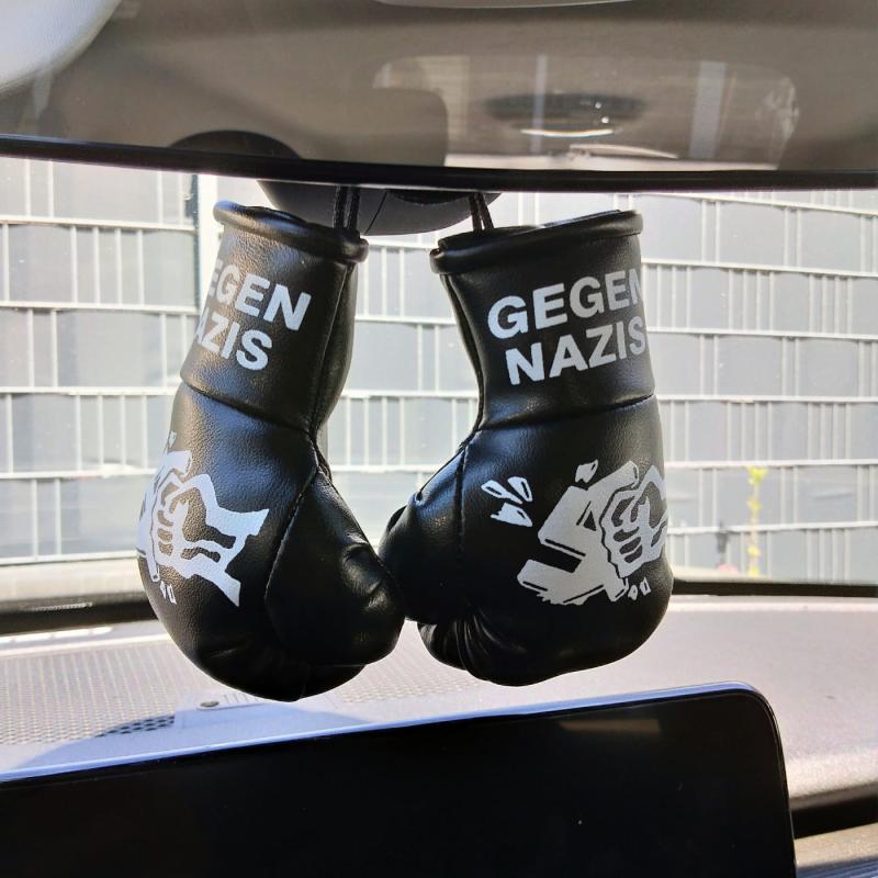 Anti-Nazi mini gloves hanging on car rearview mirror – bold protest decor