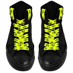 Neon yellow skull print shoelaces on black high-top sneakers